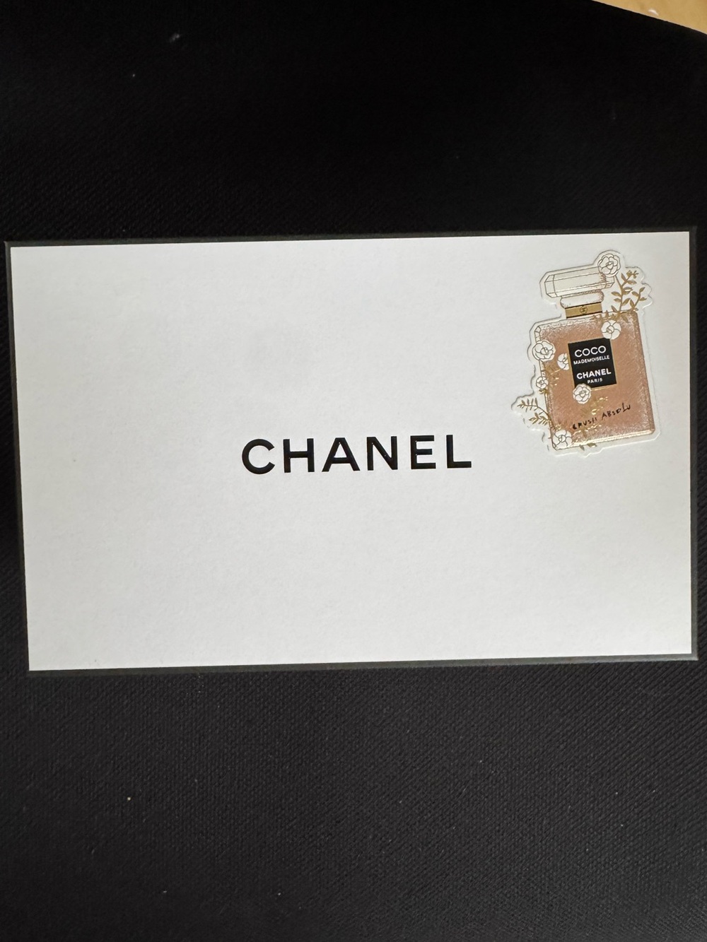 CHANEL White Card with Gold Perfume Accent